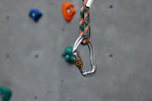 Climber removes or put a carabiner on the rope