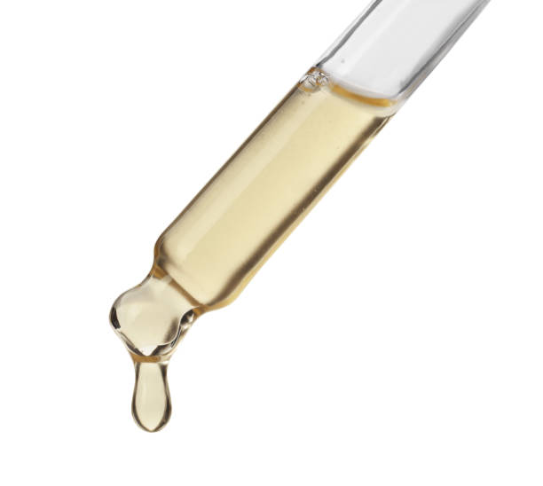 istock Dripping hydrophilic oil from pipette on white background 1433111744