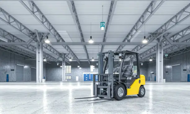 Photo of empty warehouse and yellow forklift.