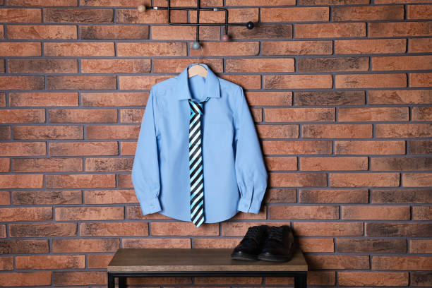 istock Shirt with tie hanging on brick wall. School uniform 1433112903
