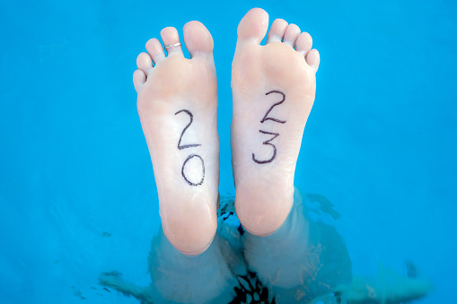 Swimmer with the year 2023 marked on her foot