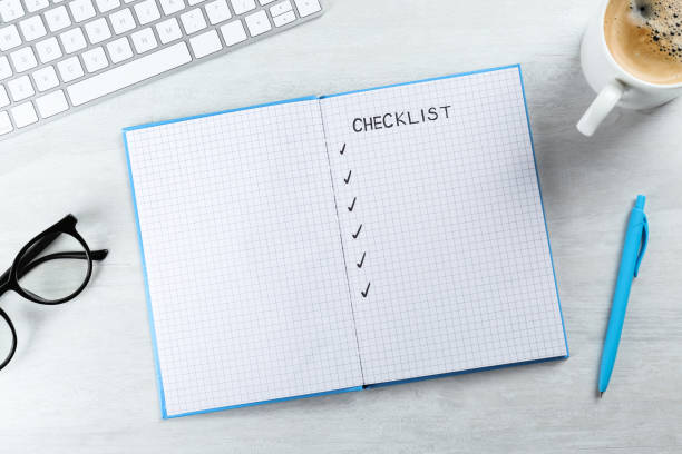 istock Notebook with inscription Checklist, computer keyboard, cup of coffee and eyeglasses on white wooden table, flat lay 1433114422
