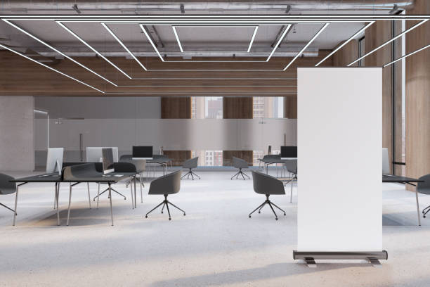 istock Front view on blank white poster with place for your logo or text on light concrete floor in spacious coworking office with minimalistic workspaces. 3D rendering, mockup 1433114926