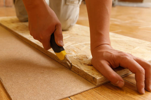 istock Carpenter cuts fiberboard with a mounting knife using OSB 1433115125