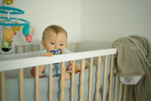 istock Cute baby boy playing in crib 1433115417