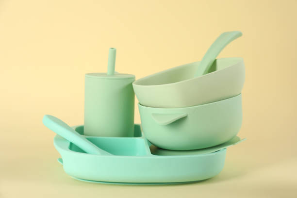 istock Set of plastic dishware on beige background. Serving baby food 1433116363