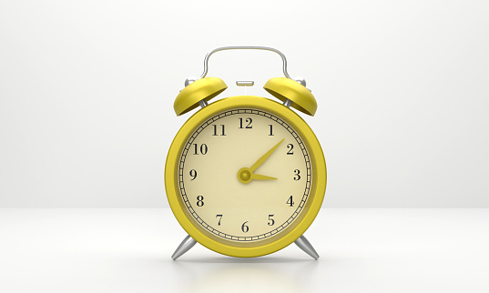 Yellow Alarm Clock On Gray Background. Time Concept.