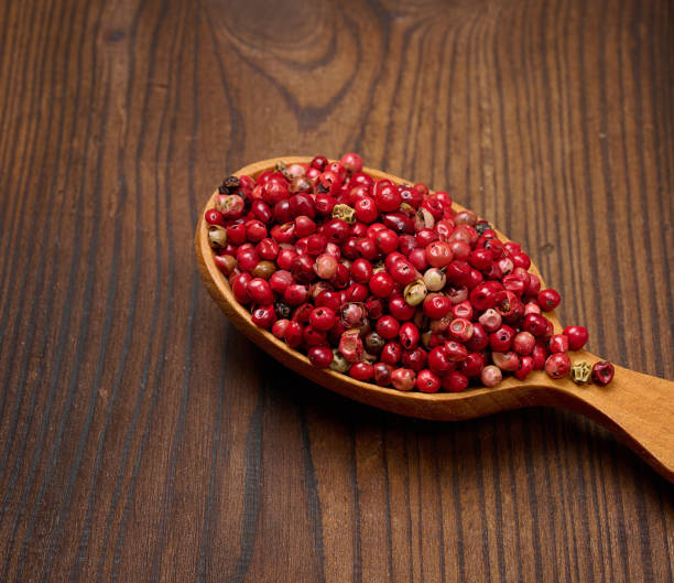 istock Red peppercorns in a wooden spoon on the table, spice 1433122746