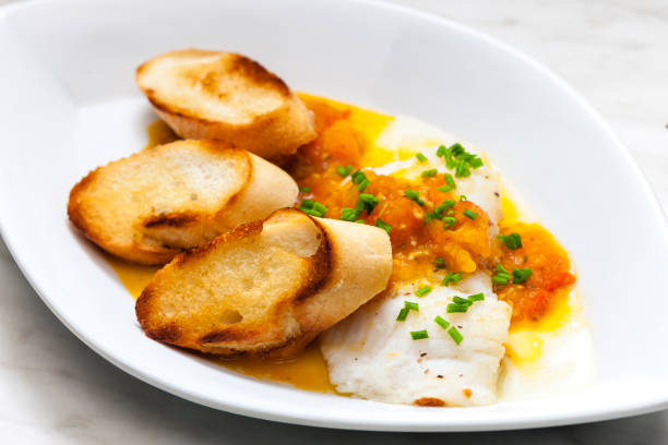 istock white fish with tomato sauce and roasted baguette slices 1433122785