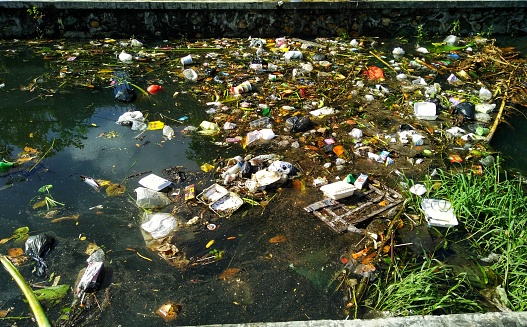 Many trash waste that thrown by people, floating and made river dirty.