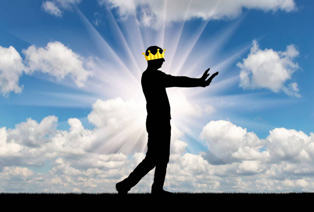 A selfish man walks, he is blind, his crown closes his eyes to see. Conceptual scene is a narcissistic and selfish person