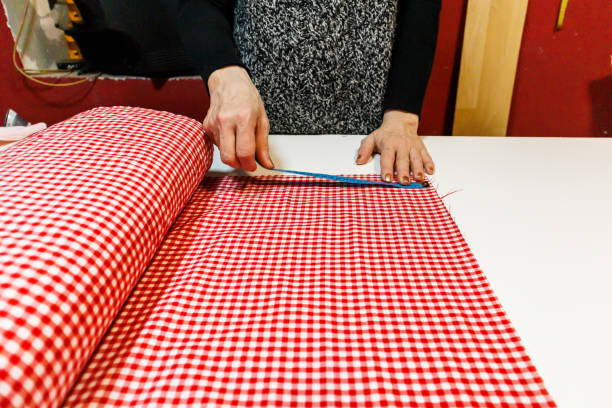 istock A woman tailor is making new clothes using scissors and a ruler. 1433126961