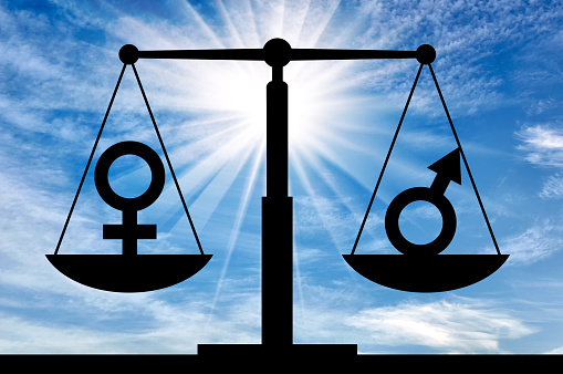 Silhouette of gender symbols on the scales of justice which are equal in rights. The concept of equal rights for women with men
