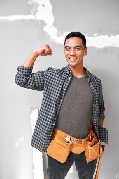 istock An attractive young Asian man poses with strong arm while doing home DIY work 1433127485