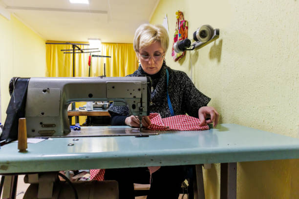 istock A woman tailor is working with a sewing machine and making a dress. 1433127592