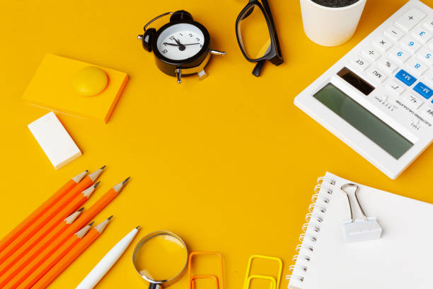 istock Stylish messy yellow desk top with various stationery top view 1433127697