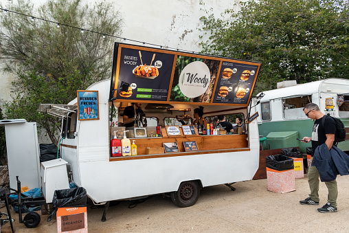 Sitges, Barcelona, Spain - October 08, 2022: Classic caravan adapted for the sale of fast food on the street