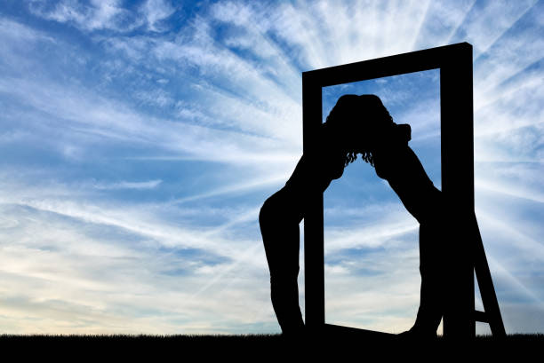 istock Silhouette of a narcissistic woman hugging her reflection in a mirror 1433129384