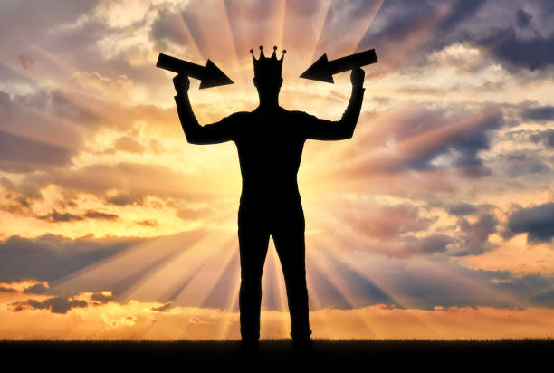 Silhouette of a selfish man with a crown on his head