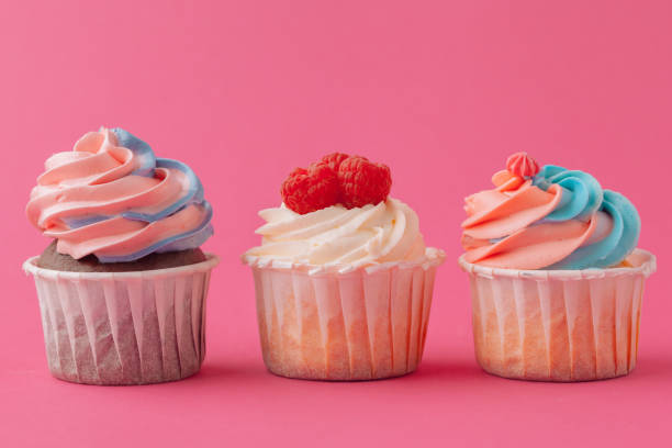 istock Yummy sweet cupcakes on light pink background 1433130109