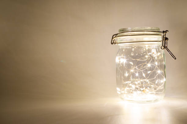 istock Fairy lights in a glass jar, Isolated on a dark background 1433131303