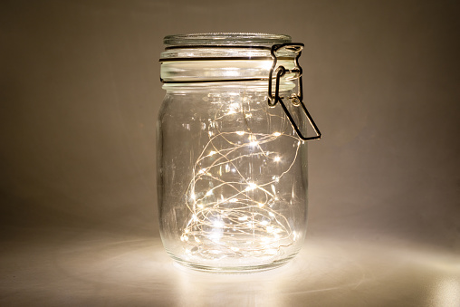 Fairy lights in a glass jar, Isolated on a dark background