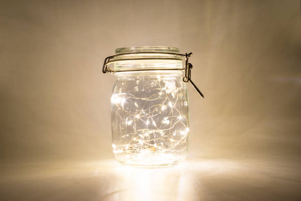 istock Fairy lights in a glass jar, Isolated on a dark background 1433131641