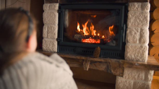 istock Young girl sitting by the fireplace 1433132311