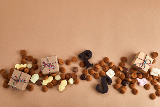 saint nicholas - sinterklaas day. traditional sweets on caramel background - sinterklaas stockfoto's en -beelden