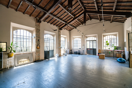 Interior of an industrial loft converted into an health club and multi purpose space. Wide angle shot.