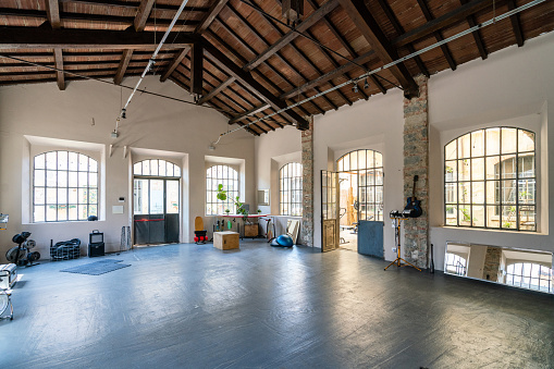 Interior of an industrial loft converted into an health club and multi purpose space. Wide angle shot.