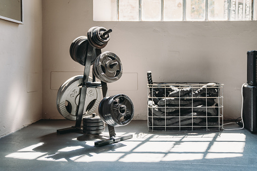 Sport equipment in a gym. Weights and ropes.