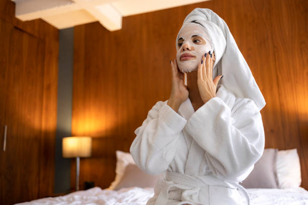 istock Woman applying sheet mask on her face 1433136951