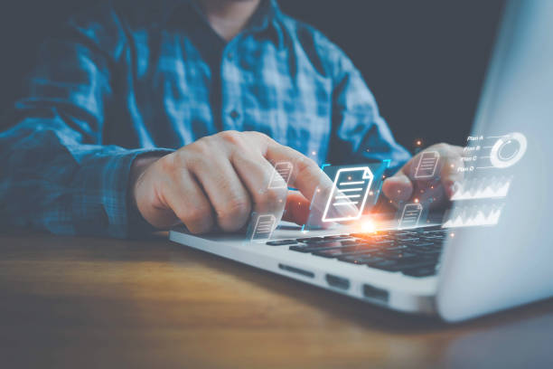 istock Hand with document icons and typing to laptop computer, Online documentation database and document management system concept. Process automation to efficiently manage files. 1433136960