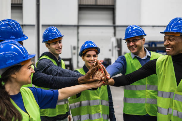 istock Team of multiracial engineers stacking hands together inside robotic factory - Tech industry concept 1433137440