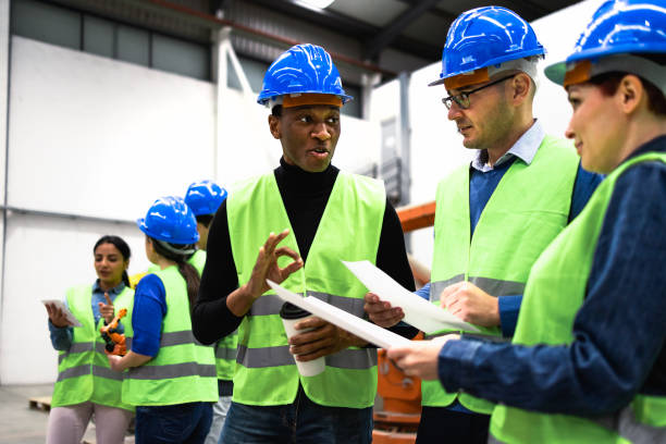 istock Team of multiracial engineers working in robotic factory - Tech industry concept 1433137498