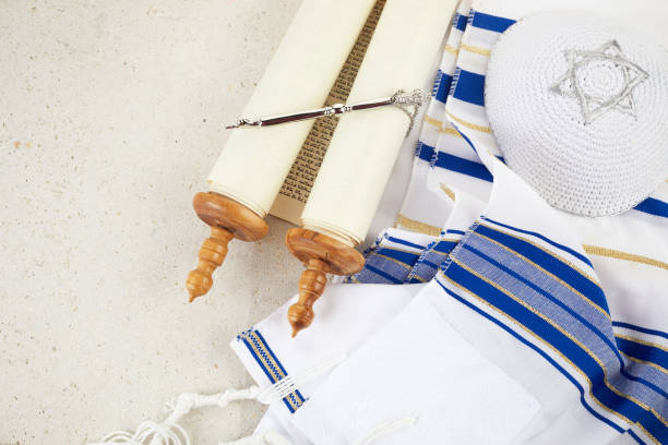 istock Simchat Torah. Jewish prayer book with torah scroll, prayer shawl tallit Orthodox religious symbols. 1433137902