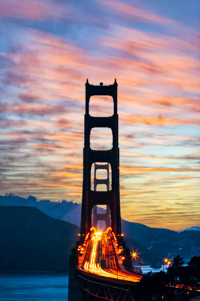 мост золотые ворота вечером в сумерках - golden gate bridge car san francisco bay san francisco county стоковые фото и изображения