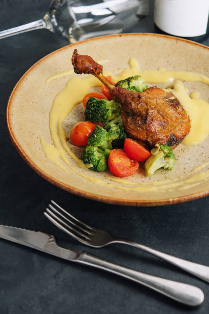 istock Confit duck leg with broccoli and tomatoes 1433138889