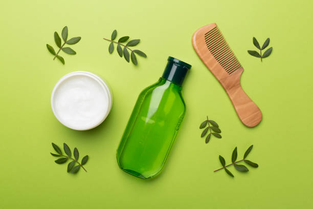 istock Shampoo and mask with herbal extract and comb on color background, top view 1433140753