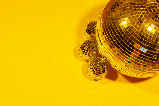 Shiny party disco balls shining in a day light over color background