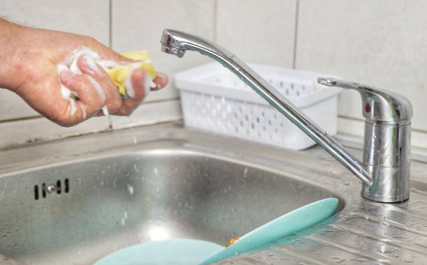 istock close-up, a man washes dishes at home 1433141799