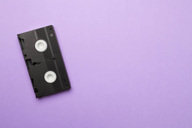 istock Old analog tape VHS cassette on color background, top view 1433141883
