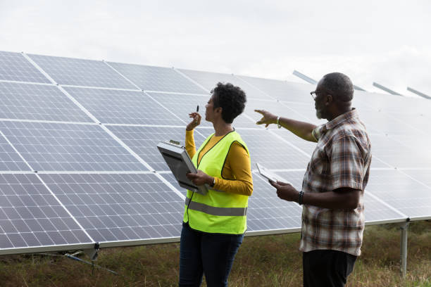 istock Mature man asks female engineer questions about solar panels 1433143217