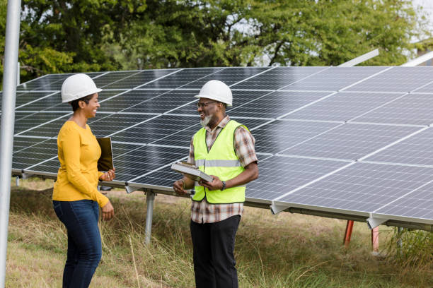 istock Female engineer smiles and talks to male solar panel technician 1433143261