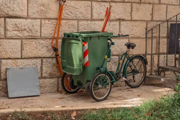 istock A tricycle with a green plastic trash can attached to it. A bicycle with a trash can. A means of transportation for garbage cleaners and janitors. 1433145321