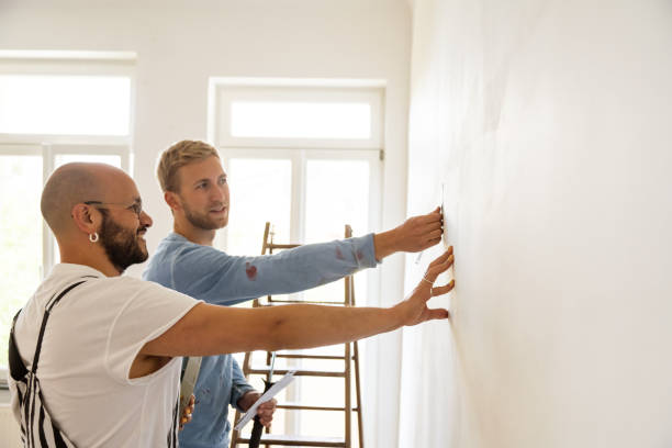 gay couple renovating their home together - home decorator house painter color swatch paint imagens e fotografias de stock