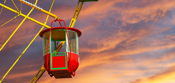 Attraction (carousel) ferris wheel against the background of a romantic evening sky