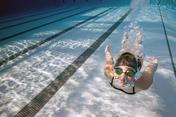 istock Playful swimmer holding her breath underwater 1433150021