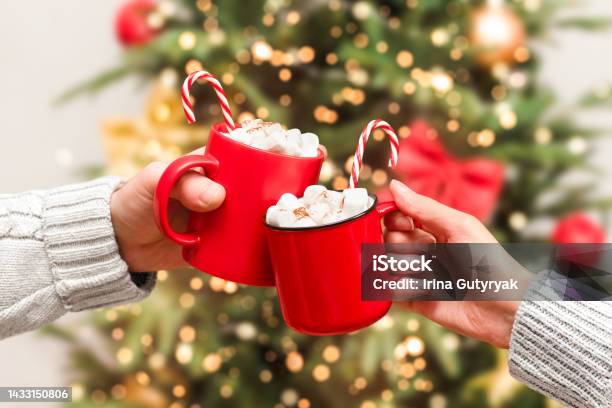 Two Red Mugs With A Hot Drink And Marshmallows Stock Photo - Download Image Now - Christmas, Hot Chocolate, Candy Cane